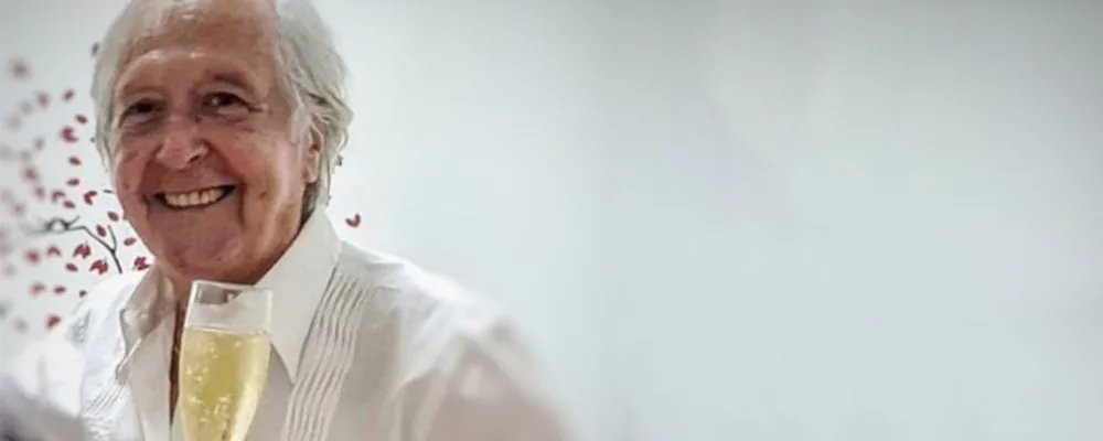 Félix Mas smiling, glass in hand